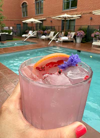 Relax with drinks by the pool. We got caught in the rain, but luckily was able to easily rush back into the hotel