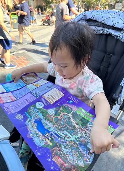 Erin excitedly looking through the Disney California Adventures map, eager to start her day!