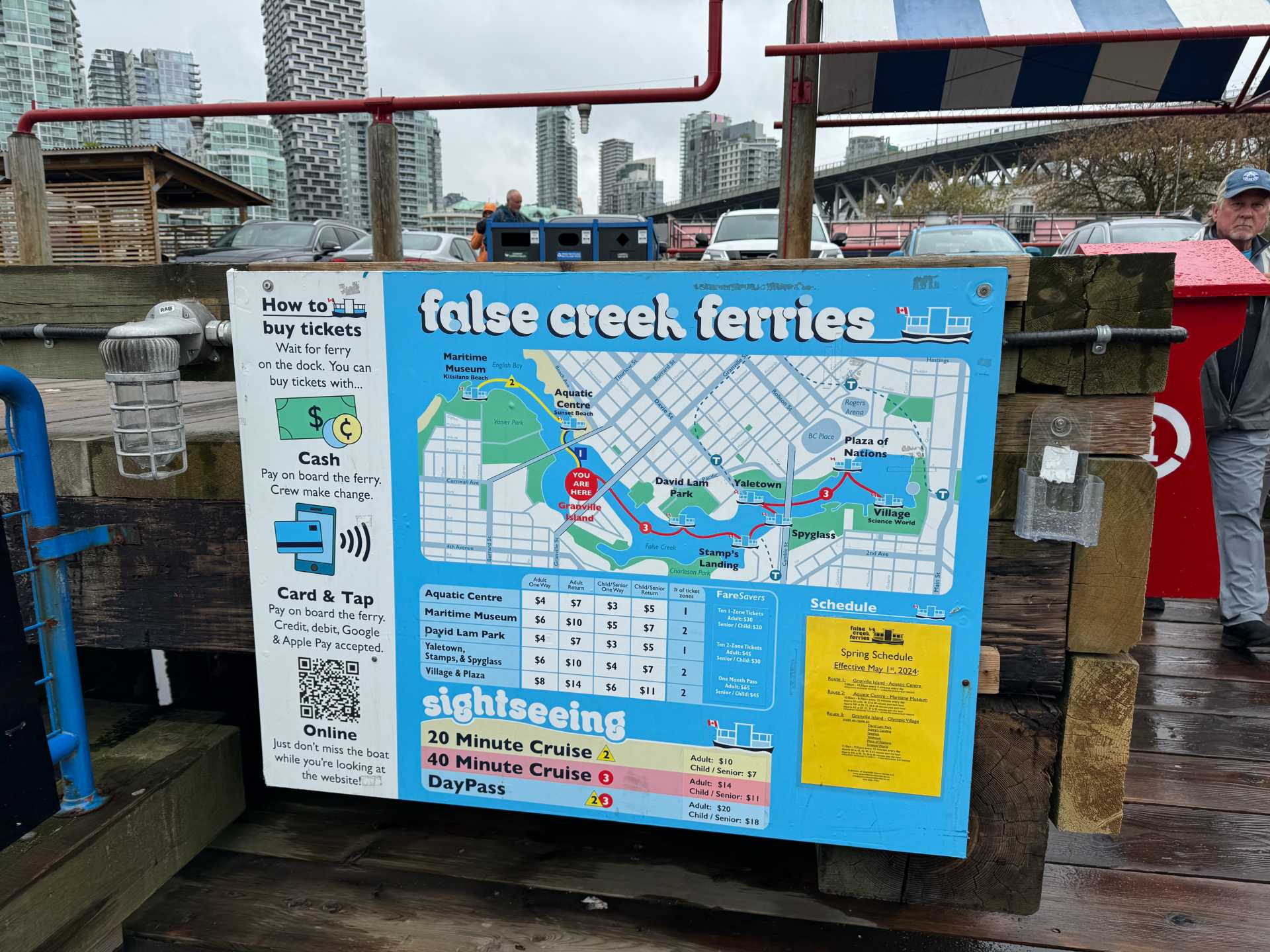 The False Creek Ferries sign with directions, routes, pricing and schedule