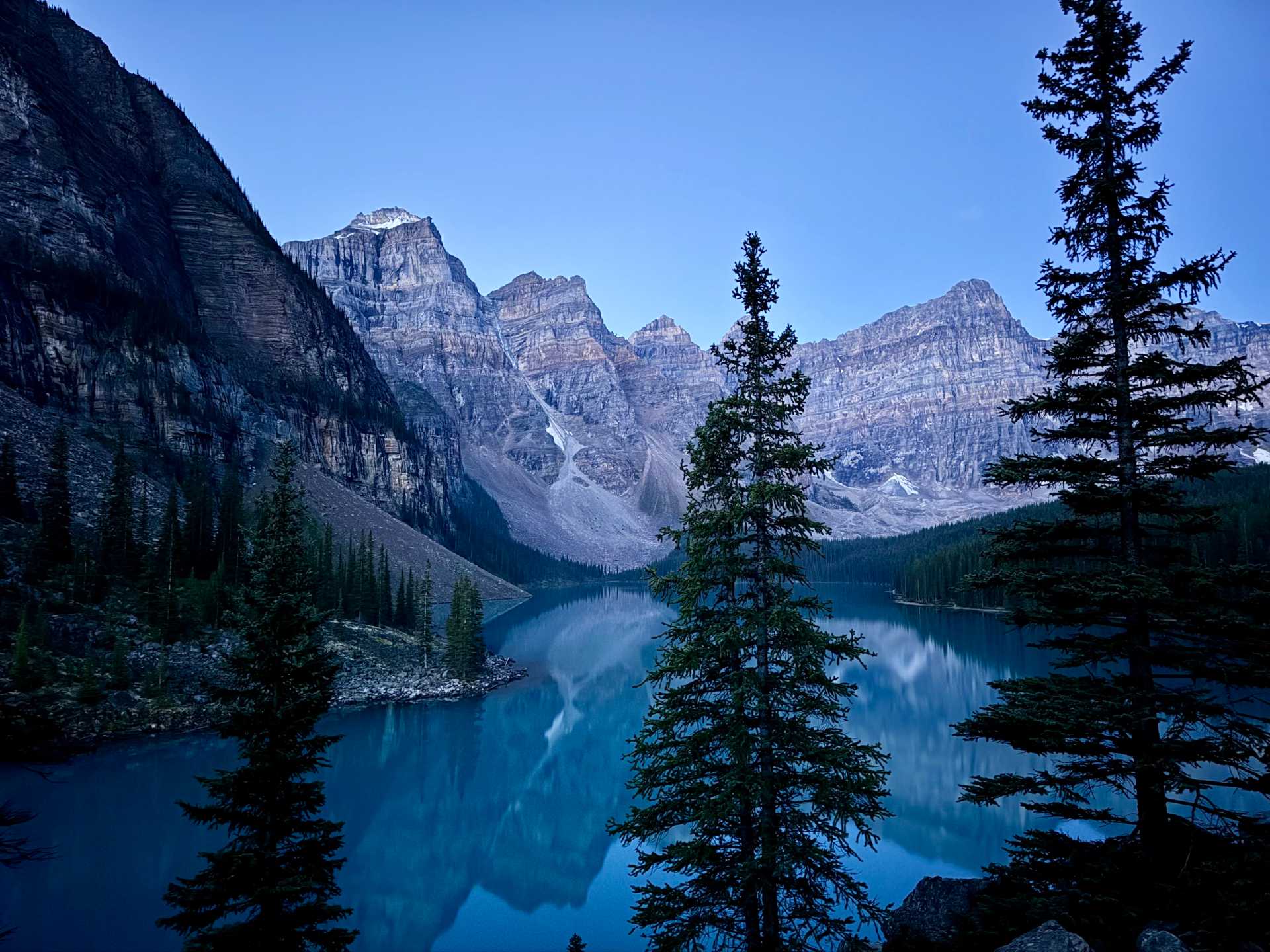 The view of Moraine Lake at 5:30am. Bundled up and ready to catch the sunrise! Tip: Don't forget those layers, it's chilly up here.