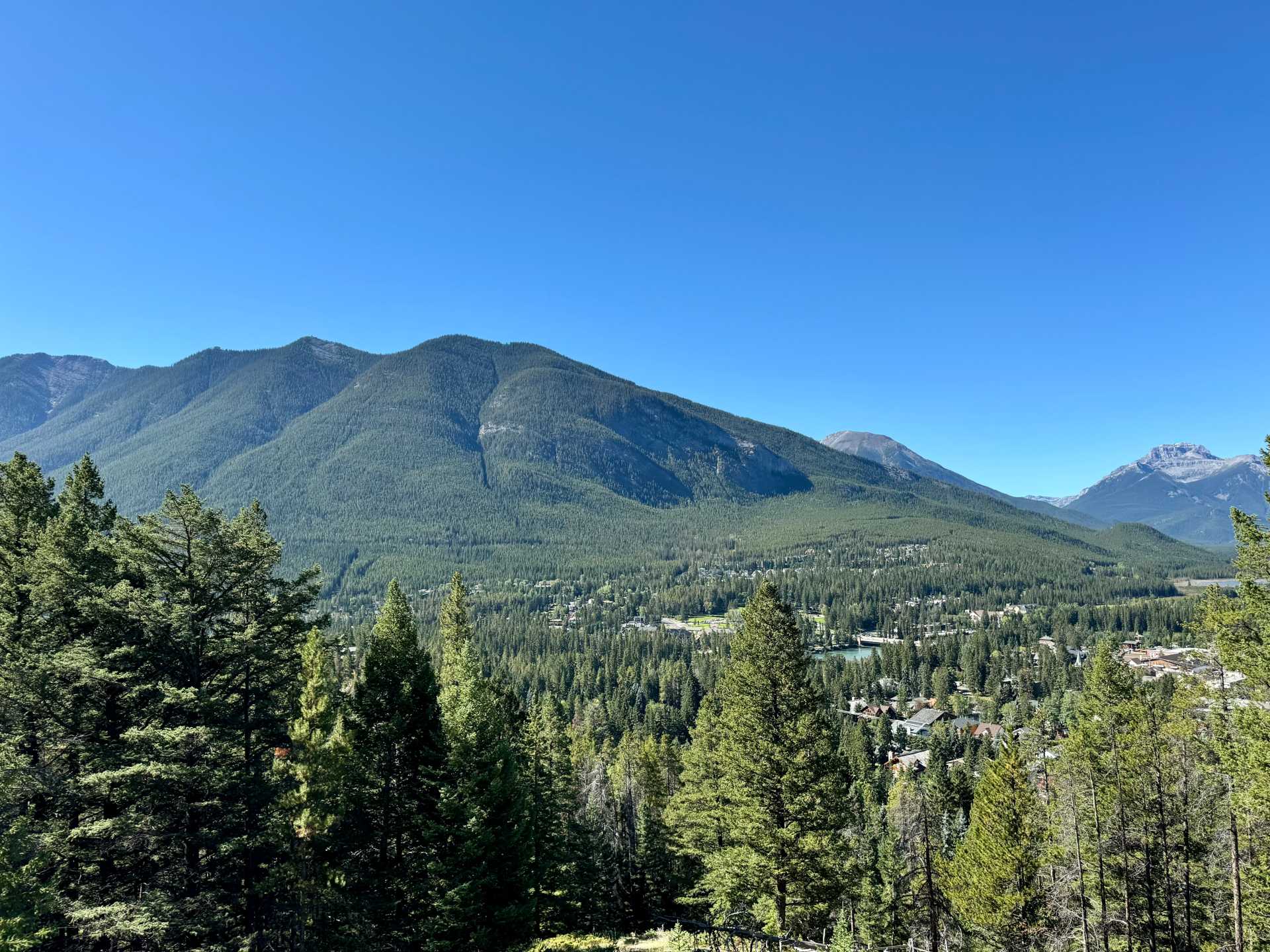 Once you get through the first small section of the Tunnel Mountain hike, you will cross a small street to continue onto the rest of the hike, which is also where the upper parking lot is located. From there you can already see some views of the city-1