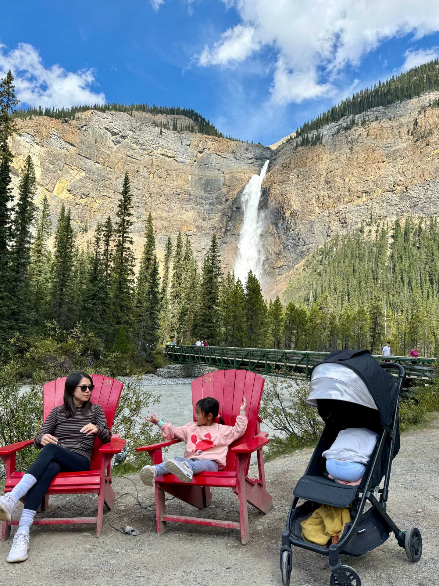 A perfect family stroll!This stroller-friendly, paved path makes the short walk to Takakkaw Falls easy for families with young kids. The iconic Parks Canada red chairs offer the perfect spot to take in the stunning scenery of Takakkaw Falls. Travel tip: These chairs are often tucked away in peaceful locations, so take a moment to sit, relax, and soak in the beauty around you-2