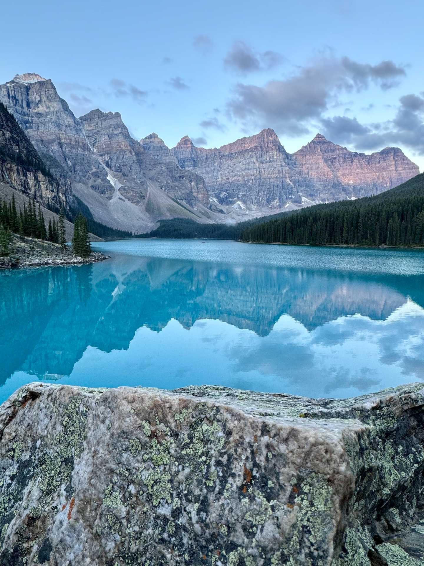 Early morning magic! Watching the first rays of sunlight light up Moraine Lake – an unforgettable sight. Pro tip: Arrive at least 30 minutes before sunrise to secure the best vantage point and capture the breathtaking colors as they change with the light-2