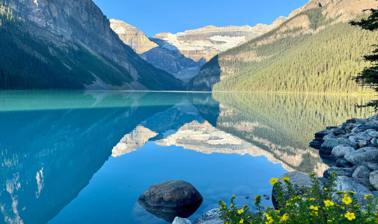 Lake Louise in the early morning sun, the lake calm and majestic with no canoes yet.