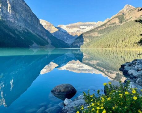 Lake Louise in the early morning sun, the lake calm and majestic with no canoes yet.