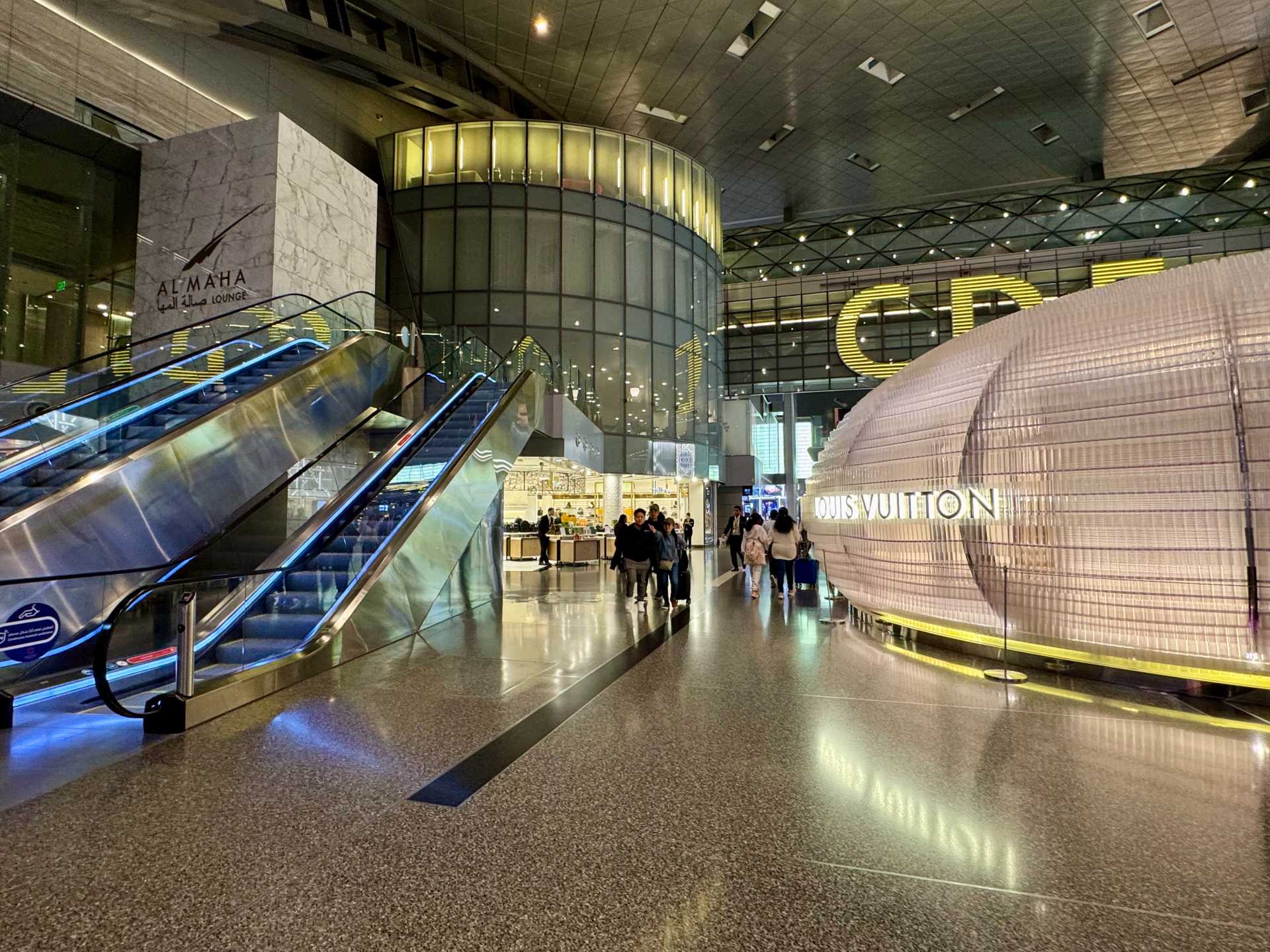 Access to the Al Maha Lounge in the main terminal can be seen here by taking the escalator up on the left. Access to the Al Mourjan Business Garden Lounge can be found next to the Louis Vuitton past the C gates near D and E. Check in before heading up the elevators to access the lounge-1