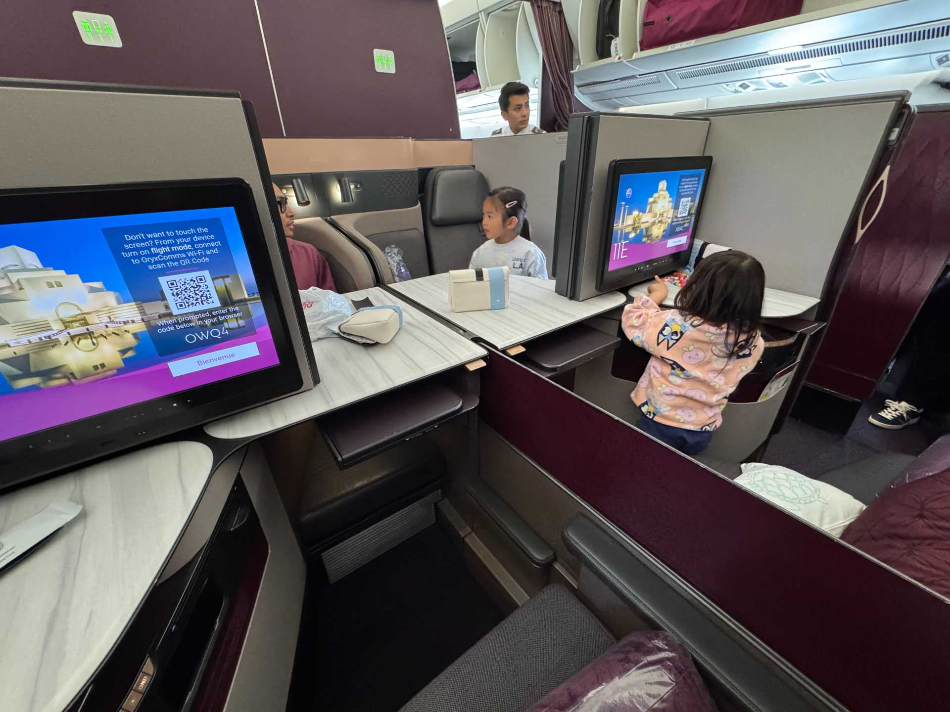 The lie-flat seats in Qatar Airways Business Class were a game-changer for our long-haul journey with kids. Our toddler was able to curl up right next to me and sleep comfortably, thanks to the extra space. Even better, the quad seating layout allowed our family of four to face each other throughout the flight—turning travel time into quality bonding time. For families flying long distances, this setup made the experience far more restful and connected-1