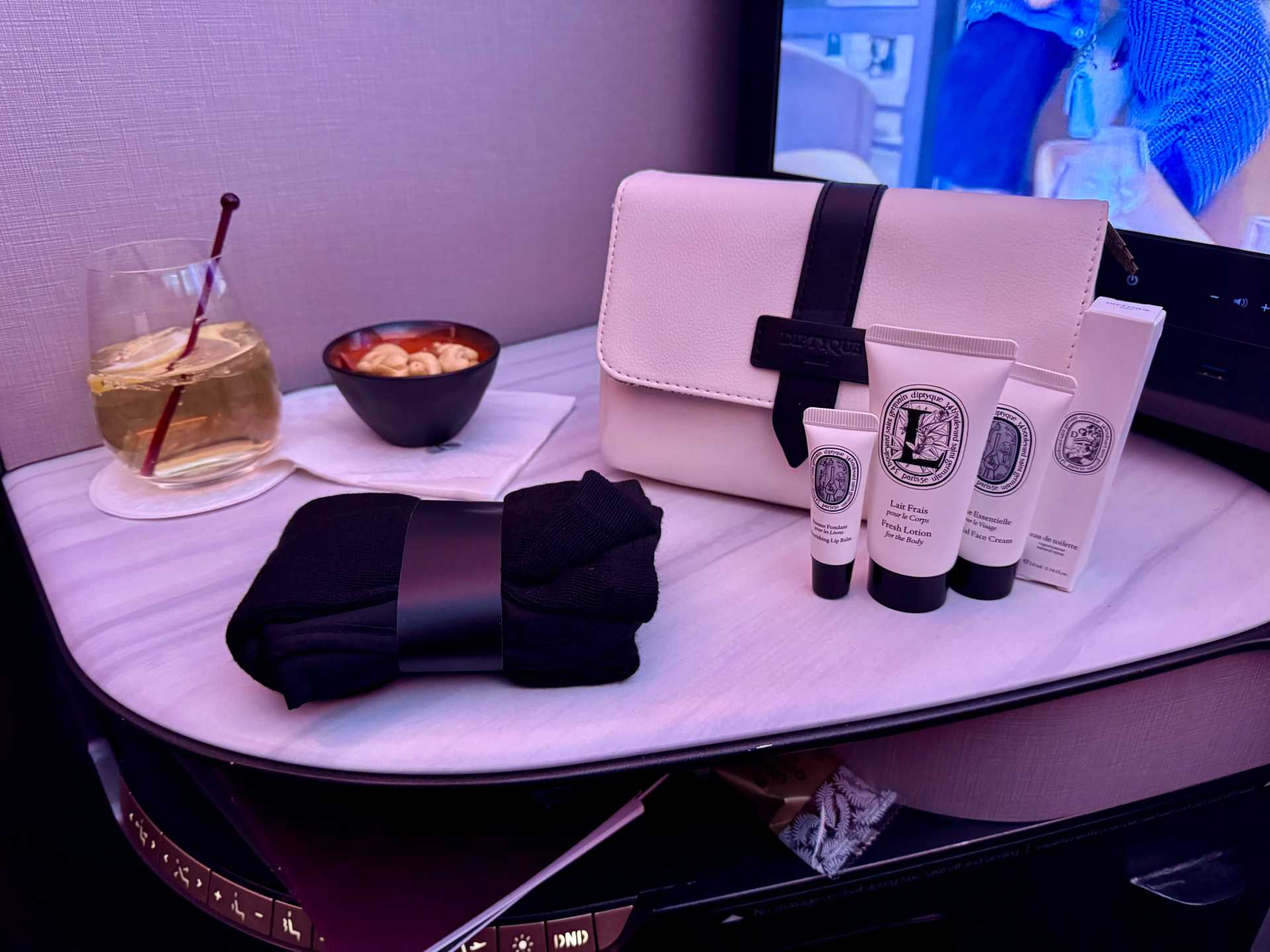 Qatar Airways Business Class came through with comfy unisex pajamas (yes, shirt and pants!) and a Diptyque amenity kit that made me feel slightly human again. Not quite a spa day—but for 35,000 feet? I’ll take it-1